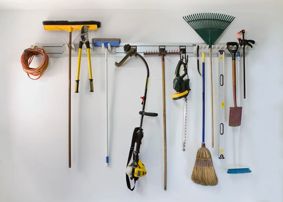 Wall mounted garage shelves holds holds garden tools clears up the garage floor